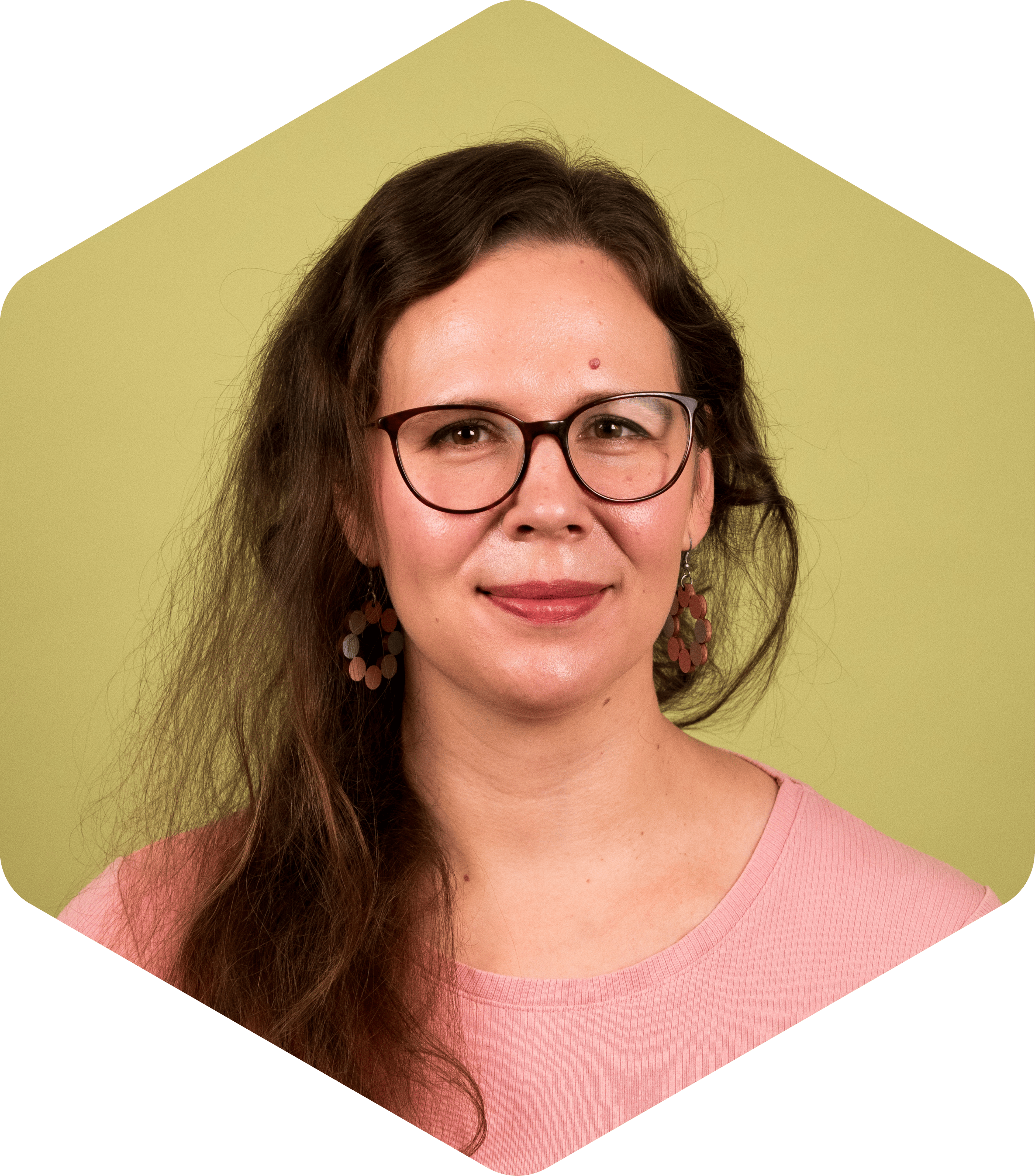 Jenni wearing a pink top, facing the camera on a light green background.