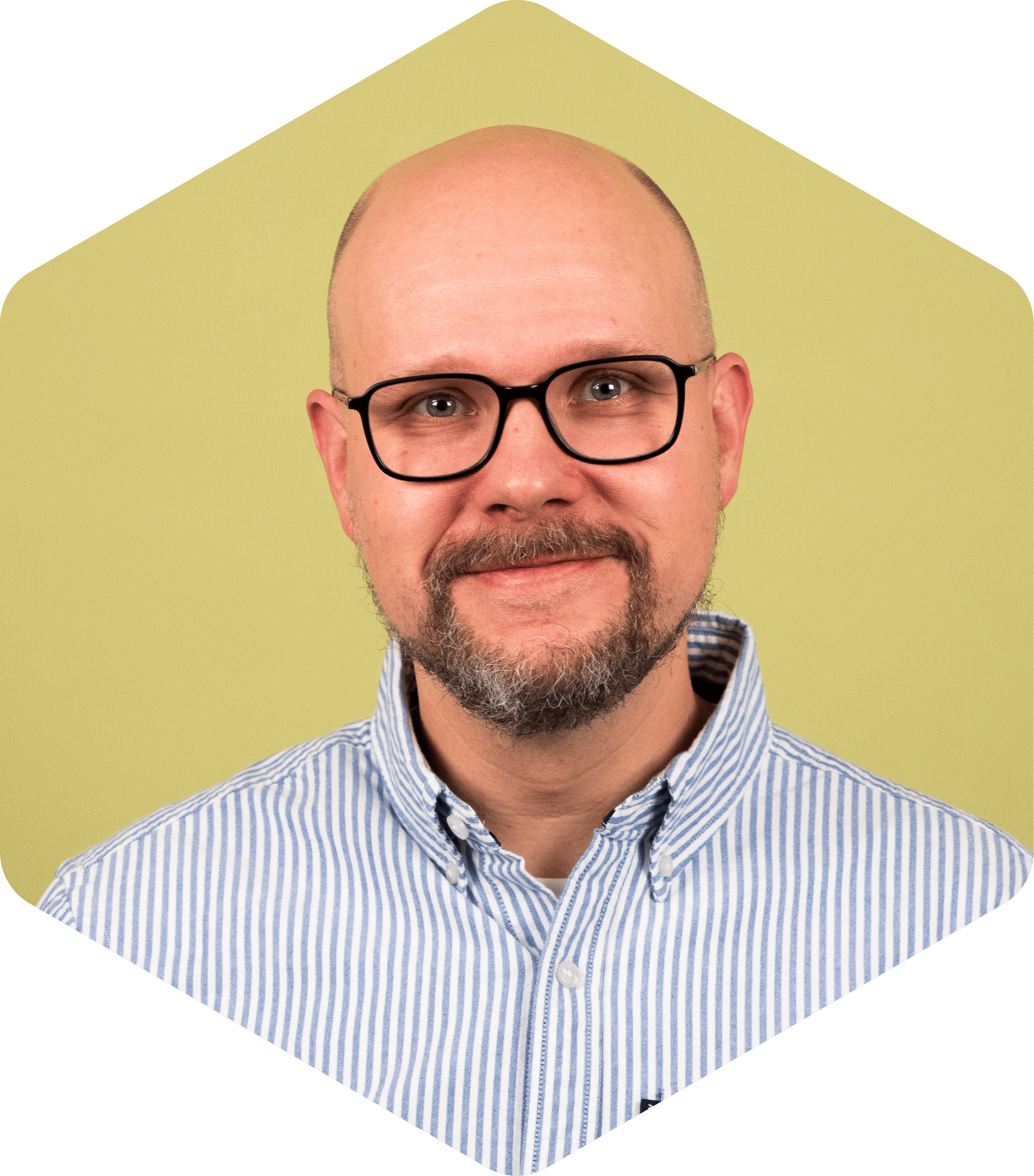 Mikko wearing glasses and a striped button-down shirt on a light green background.