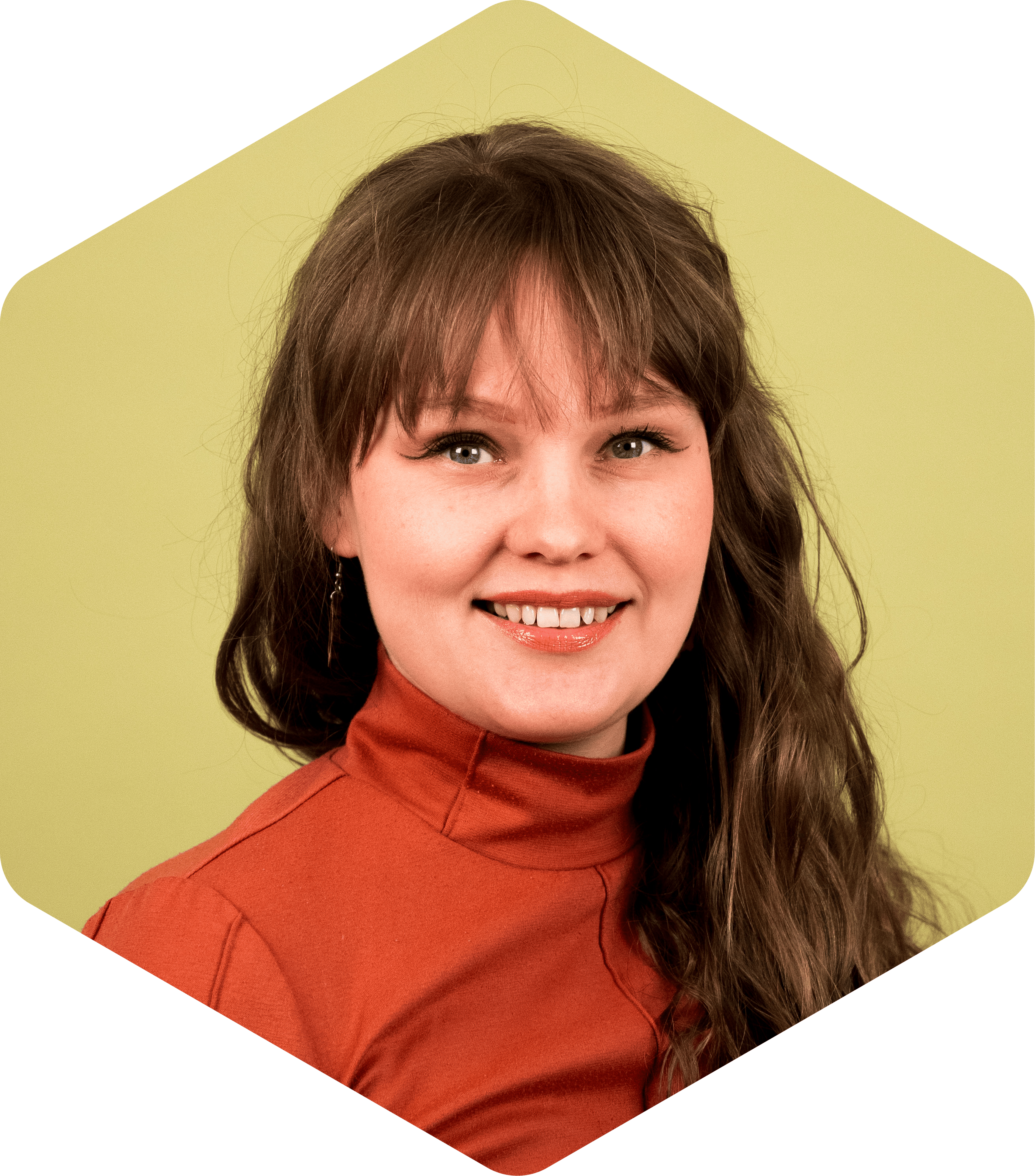 Sari smiling, wearing an orange top on a light green background.