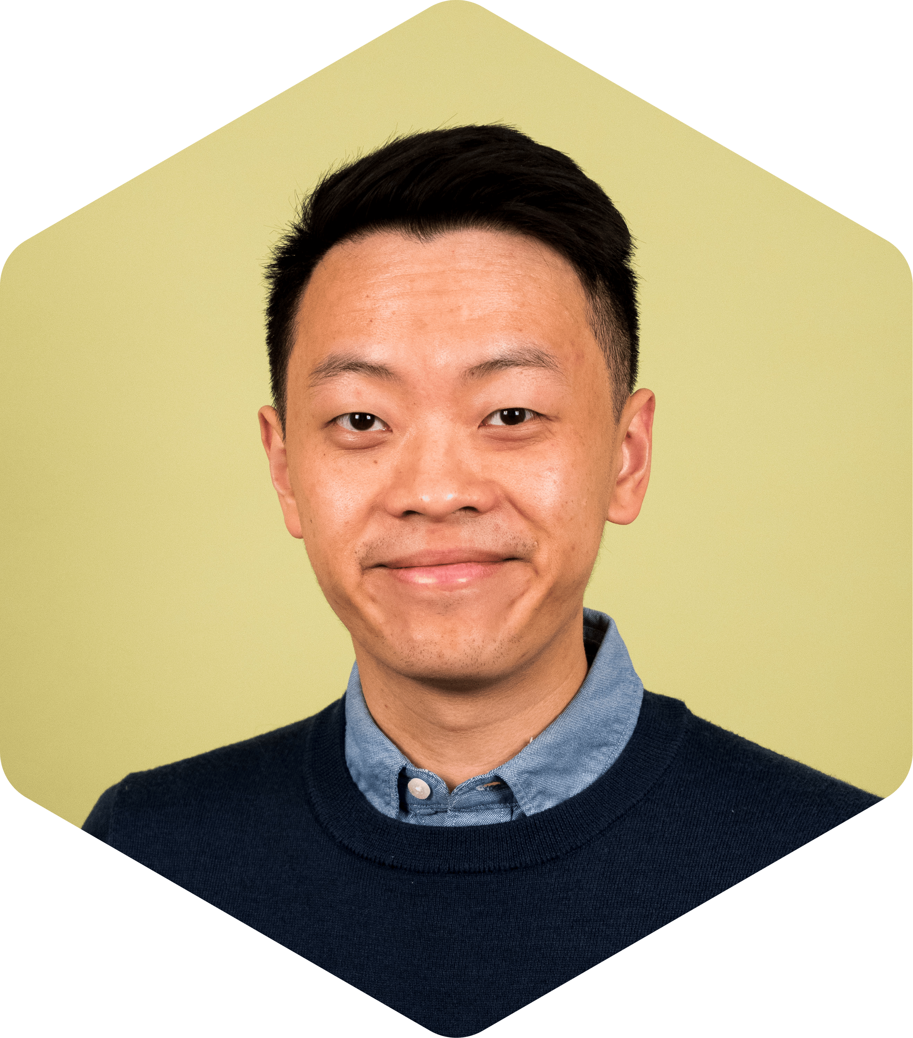 Portrait of Yifan on a green background, looking at the camera with a slight smile.