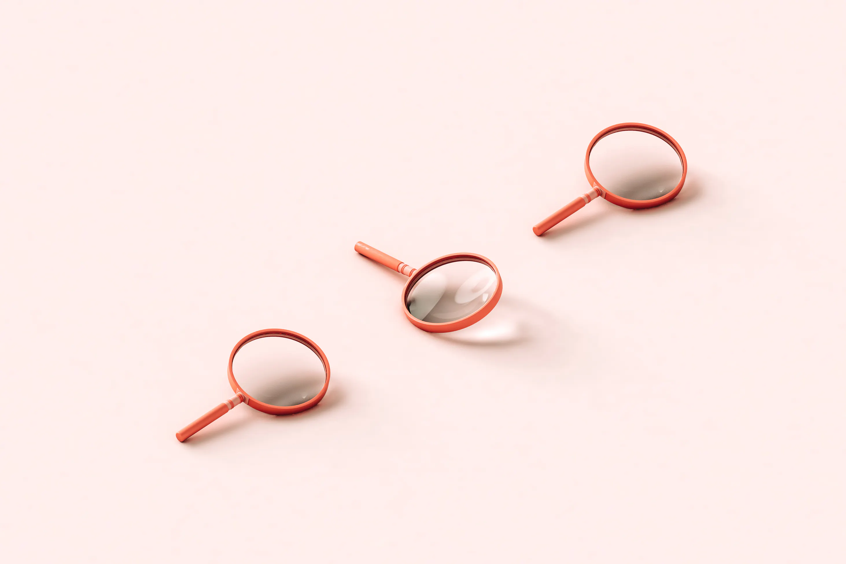 Three pink 3D magnifying glasses on light pink background.