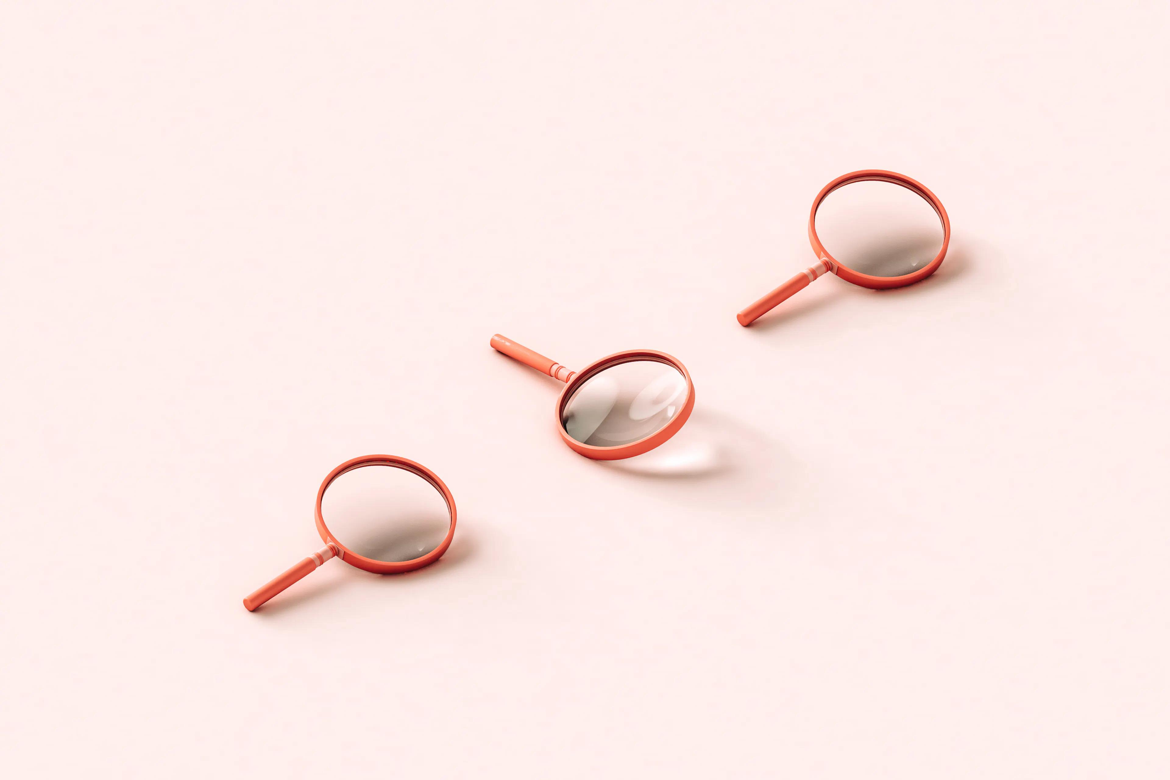 Three pink 3D magnifying glasses on light pink background.