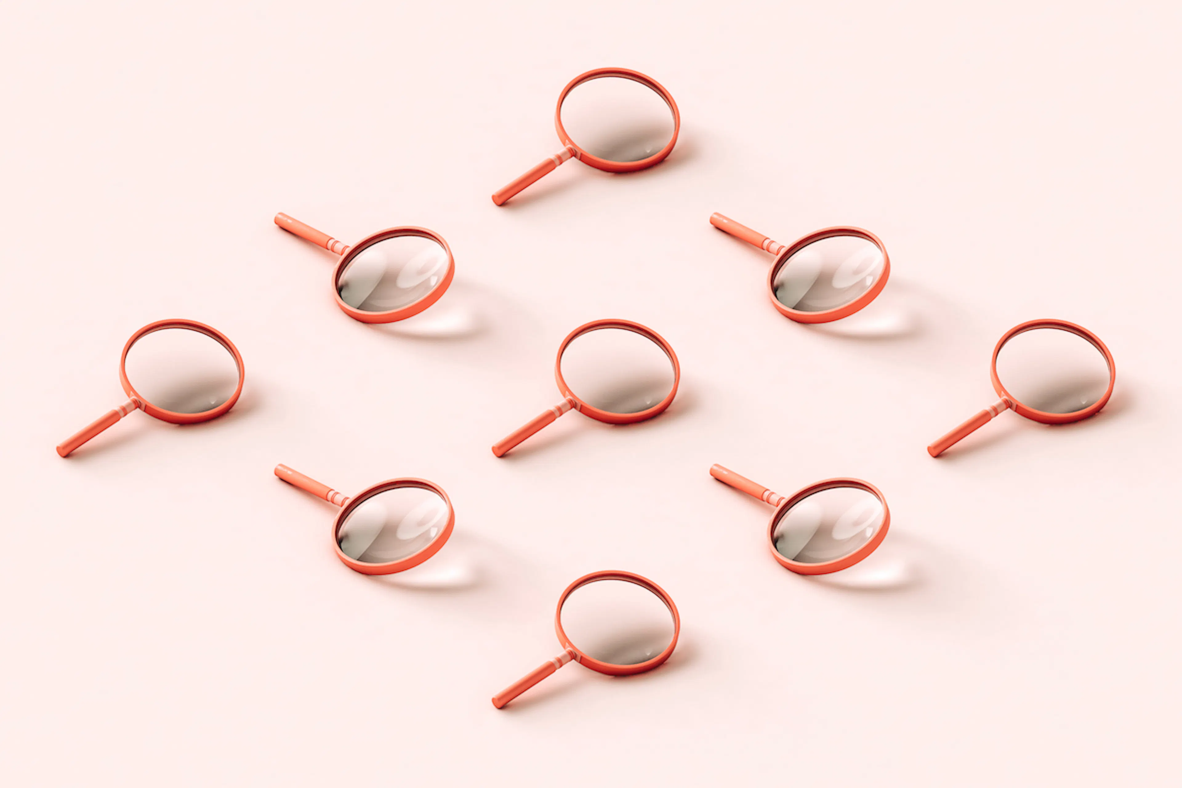 Nine pink 3D magnifying glasses arranged in a reclining diamond shape on pale pink background.