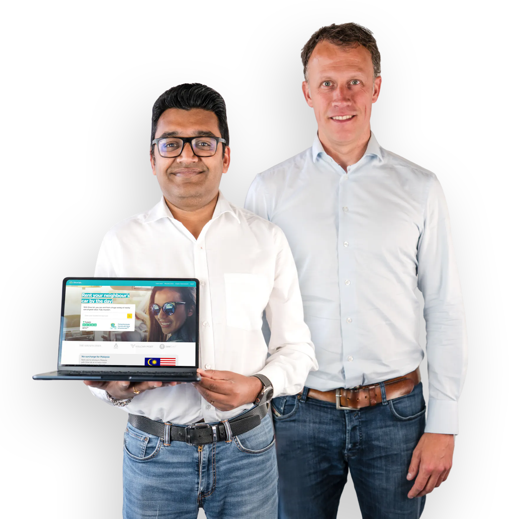 Drive lah founders Gaurav Singhal and Dirk-Jan der Horst. Both founders are smiling and wearing light button-down shirts and jeans. Gaurav is holding a laptop that's open to the Drive lah home page.