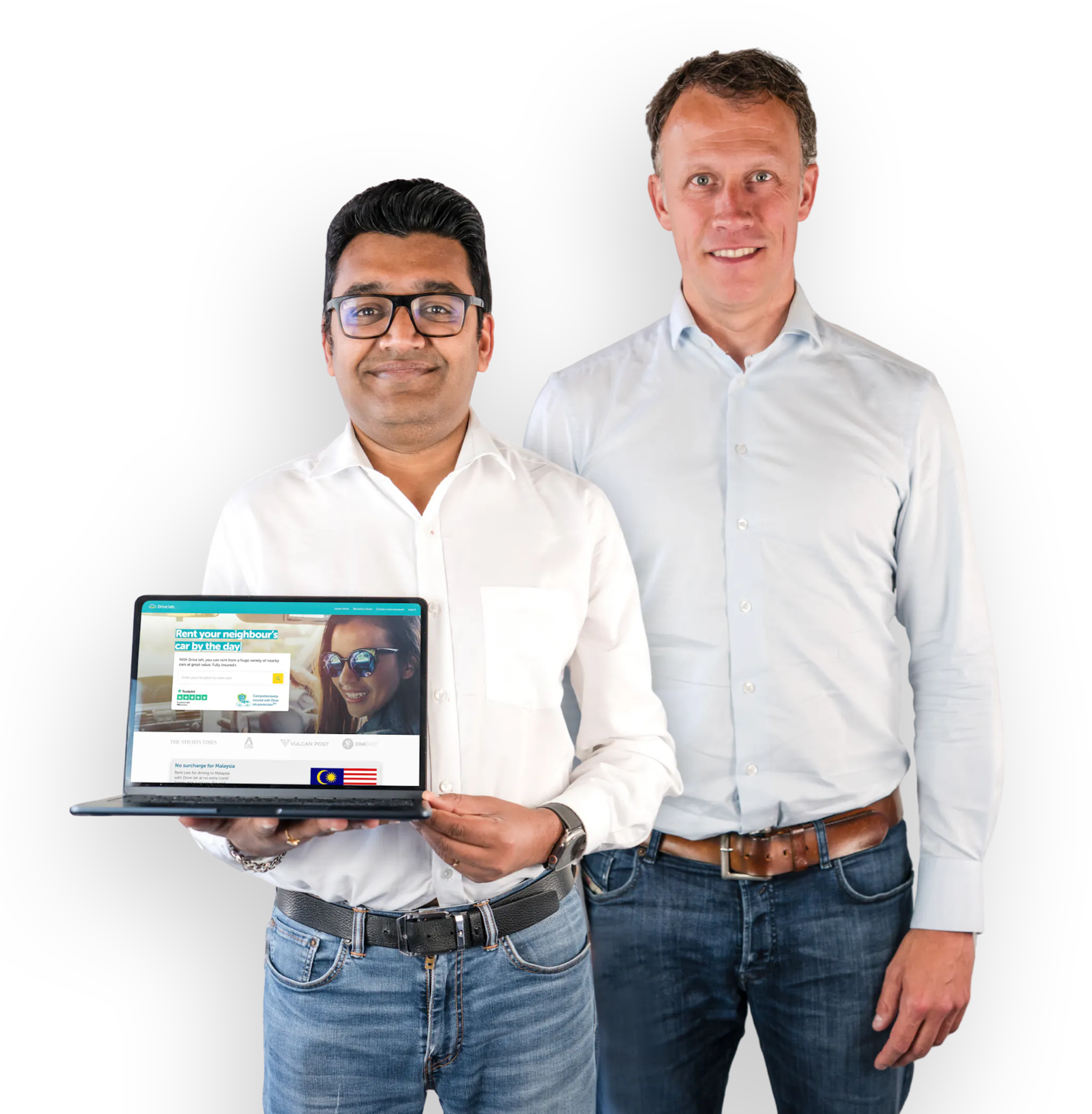 Drive lah founders Gaurav Singhal and Dirk-Jan der Horst. Both founders are smiling and wearing light button-down shirts and jeans. Gaurav is holding a laptop that's open to the Drive lah home page.