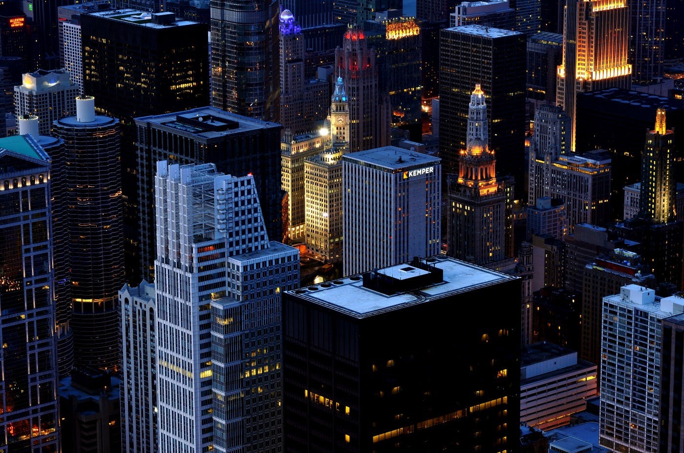 An aerial view of a city with skyscrapers at dusk. Photo by Alex Shutin on Unsplash.