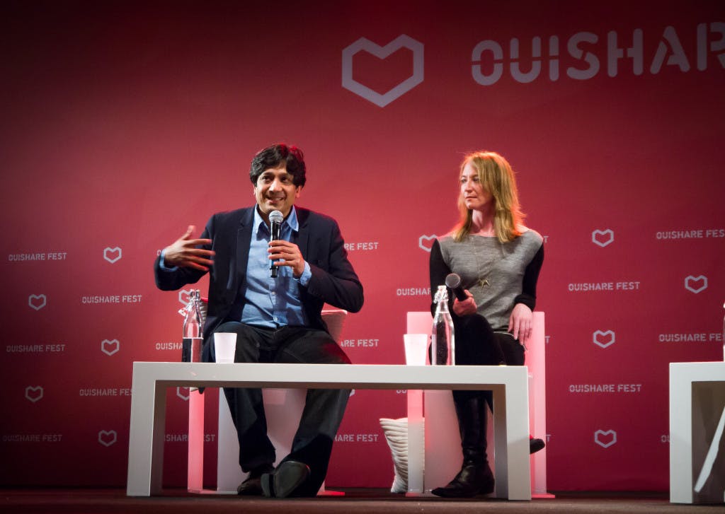 Arun Sundararajan speaking in a panel discussion at OuiShareFest. Photo by Antti Virolainen.