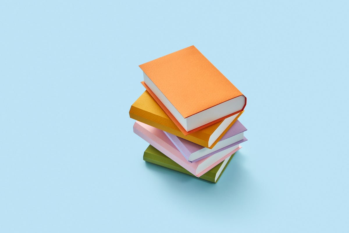 Marketplace Glossary: a stack of colorful books on a blue background