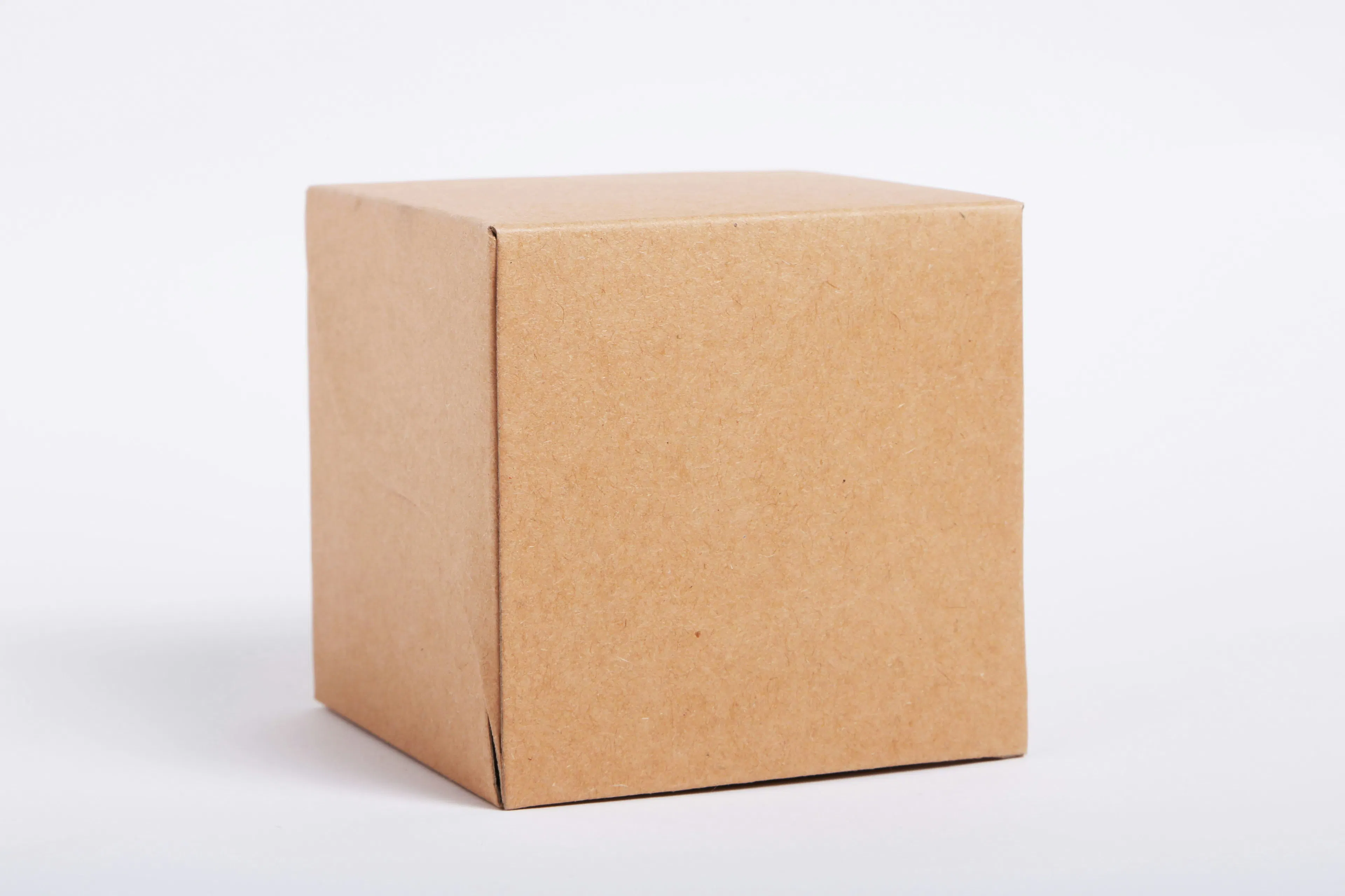 A cardboard package against a white background. Photo by Giorgio Trovato on Unsplash.