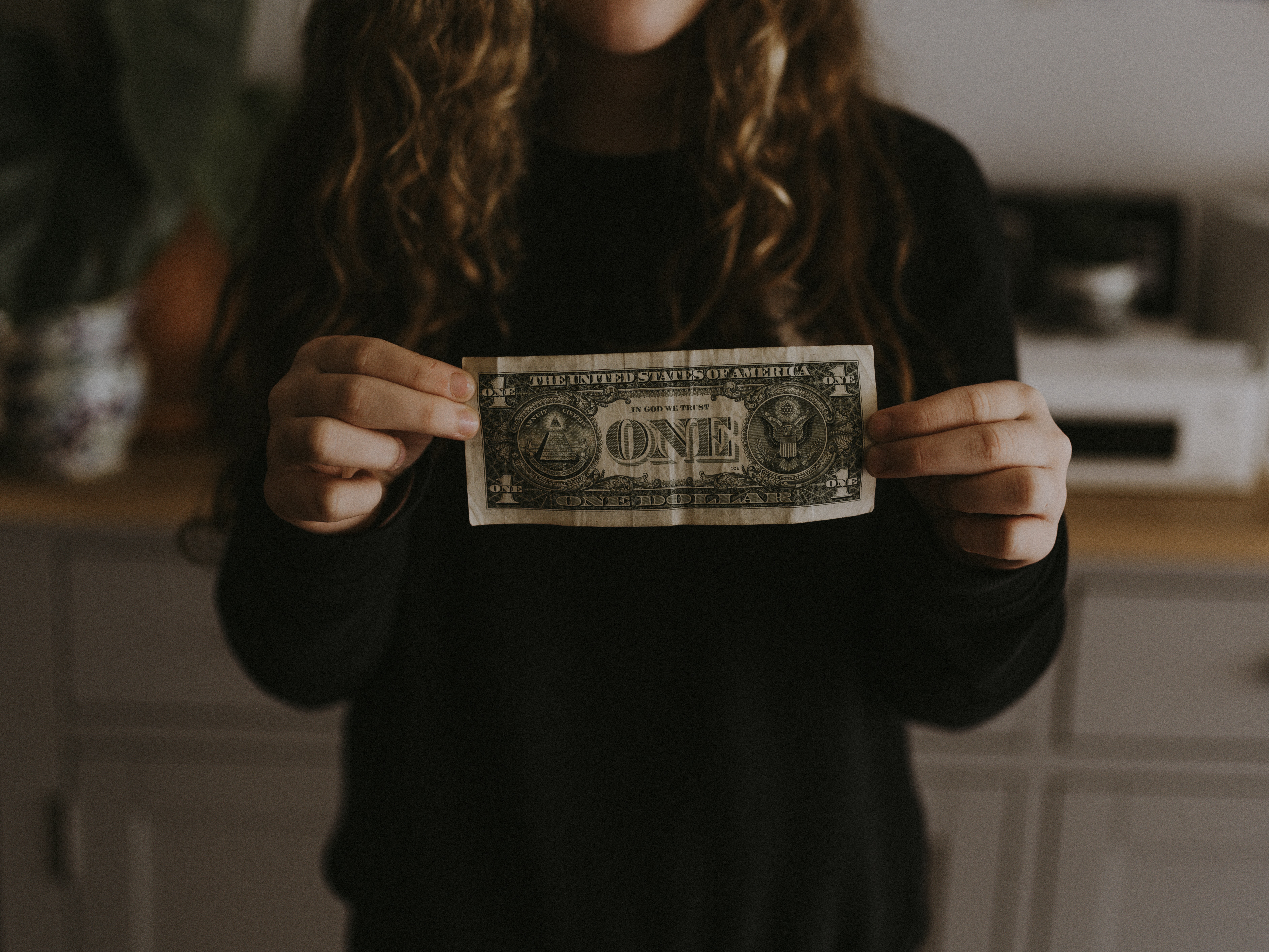 Human holding up inteational currency 