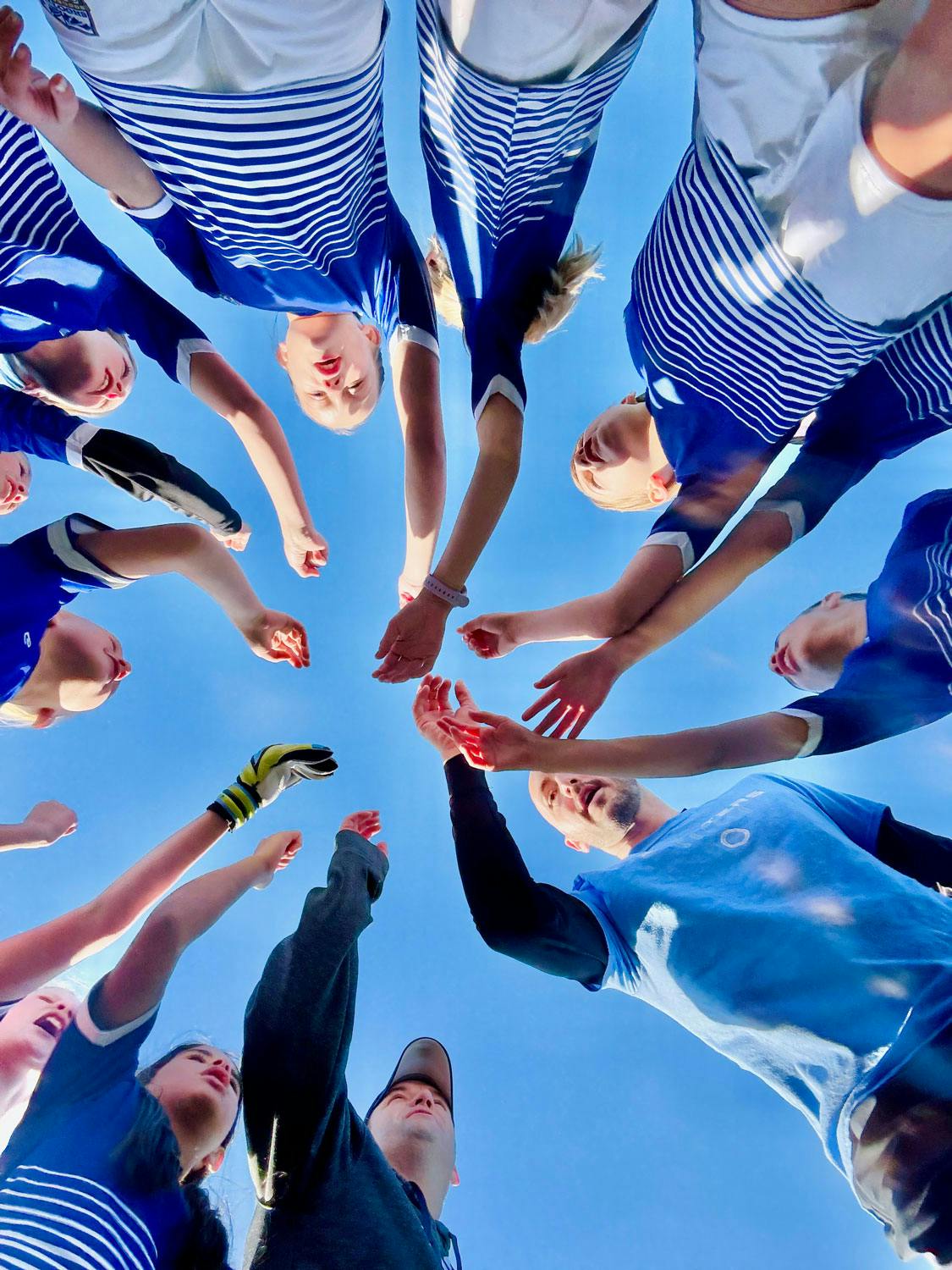 Shooters huddle with teams hands together