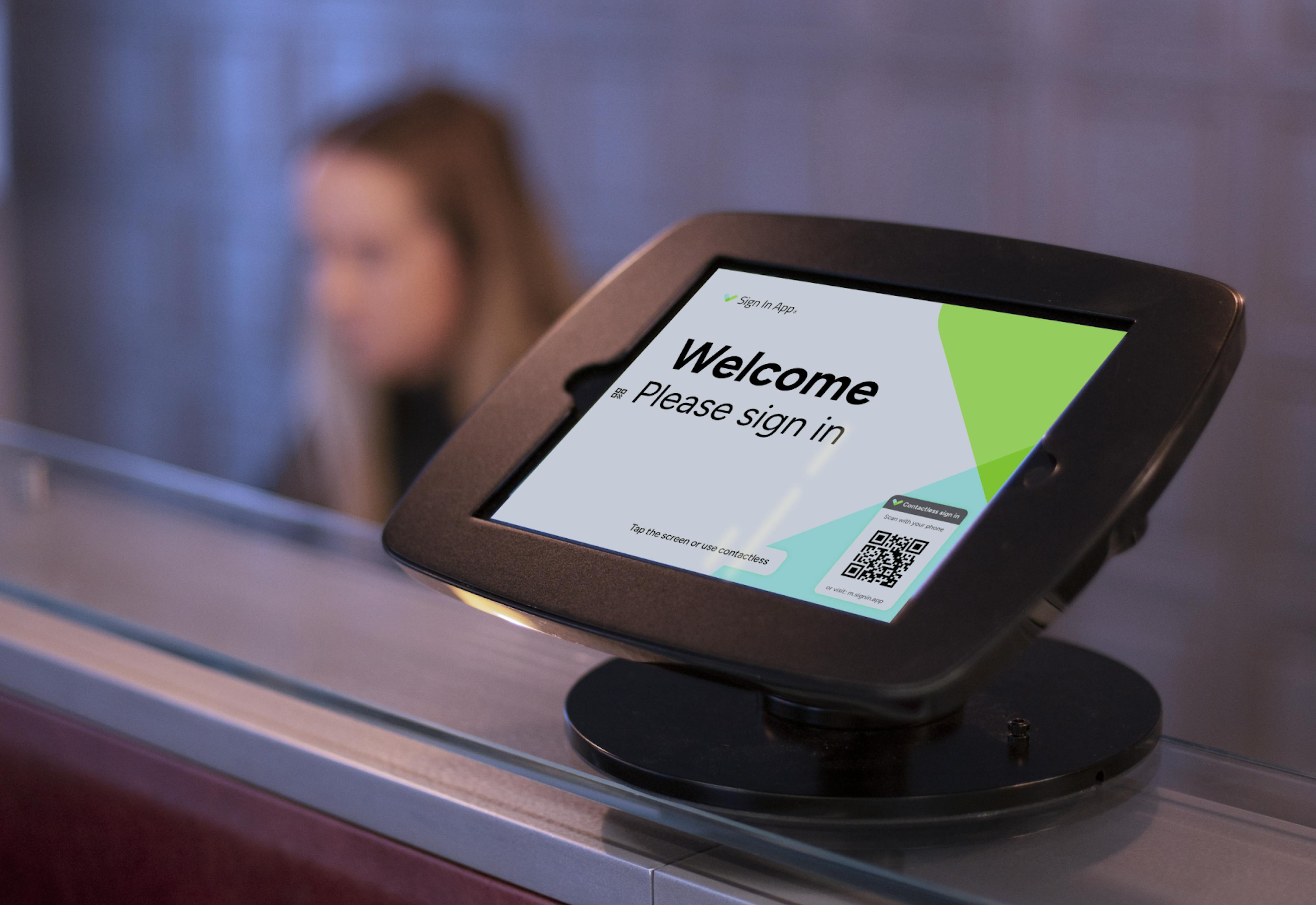 An image of Sign In App's visitor management system on a reception desk