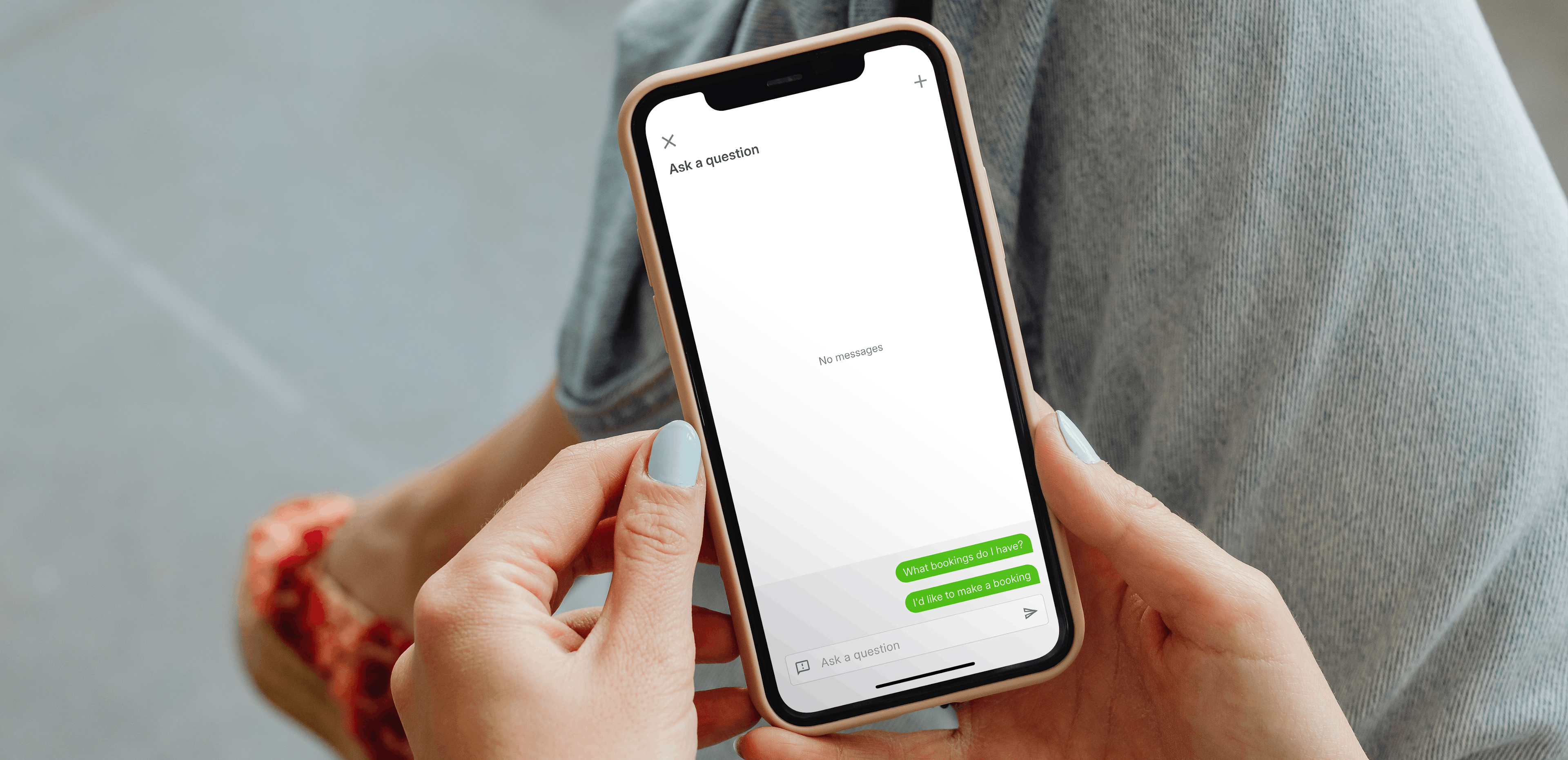 A photo with an over the shoulder view of a woman on her phone using the AI Assistant on Companion app