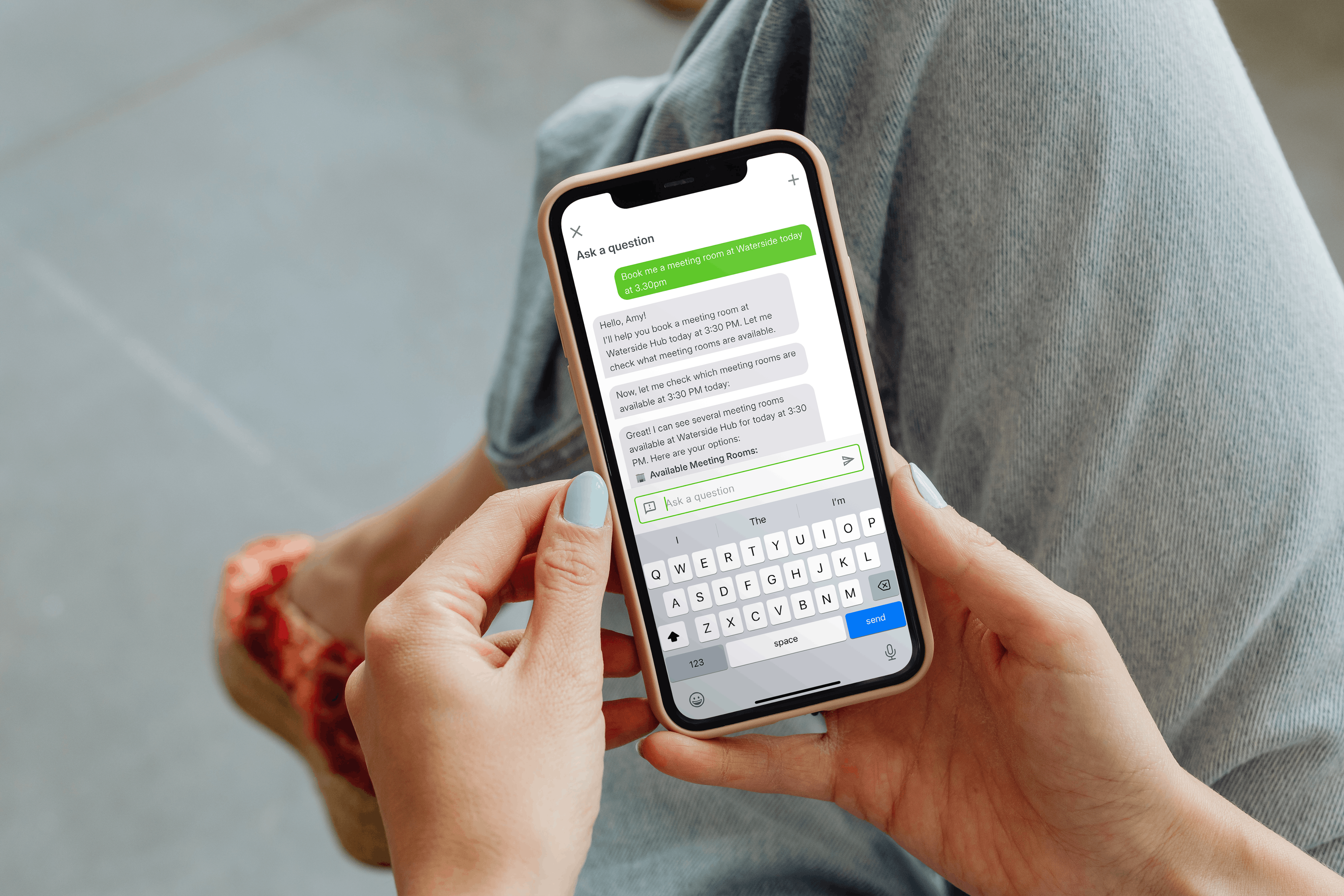 A photo with an over the shoulder view of a woman on her phone using the AI Assistant on Companion app