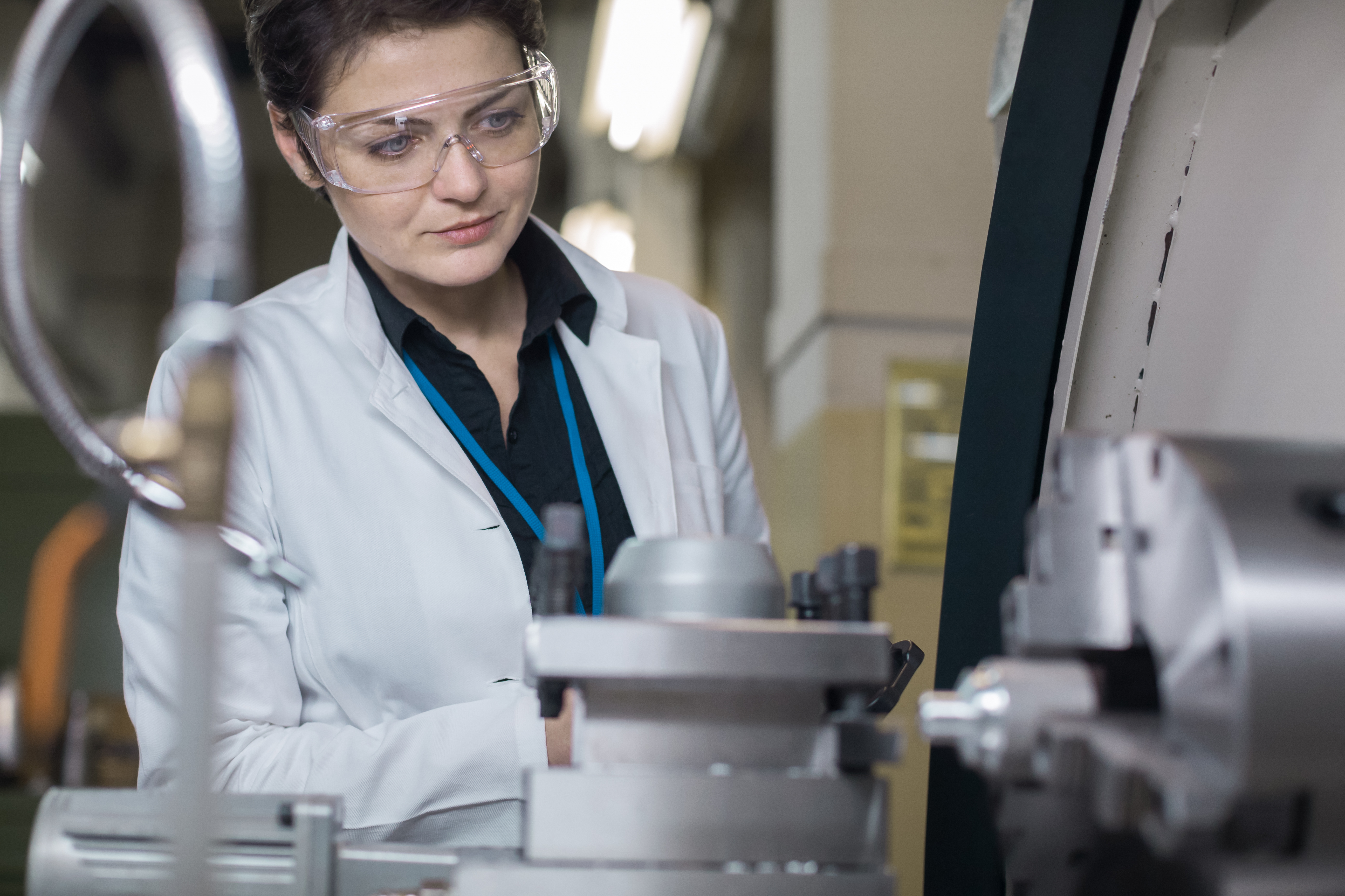 Woman in white coats and glasses in a laboratory