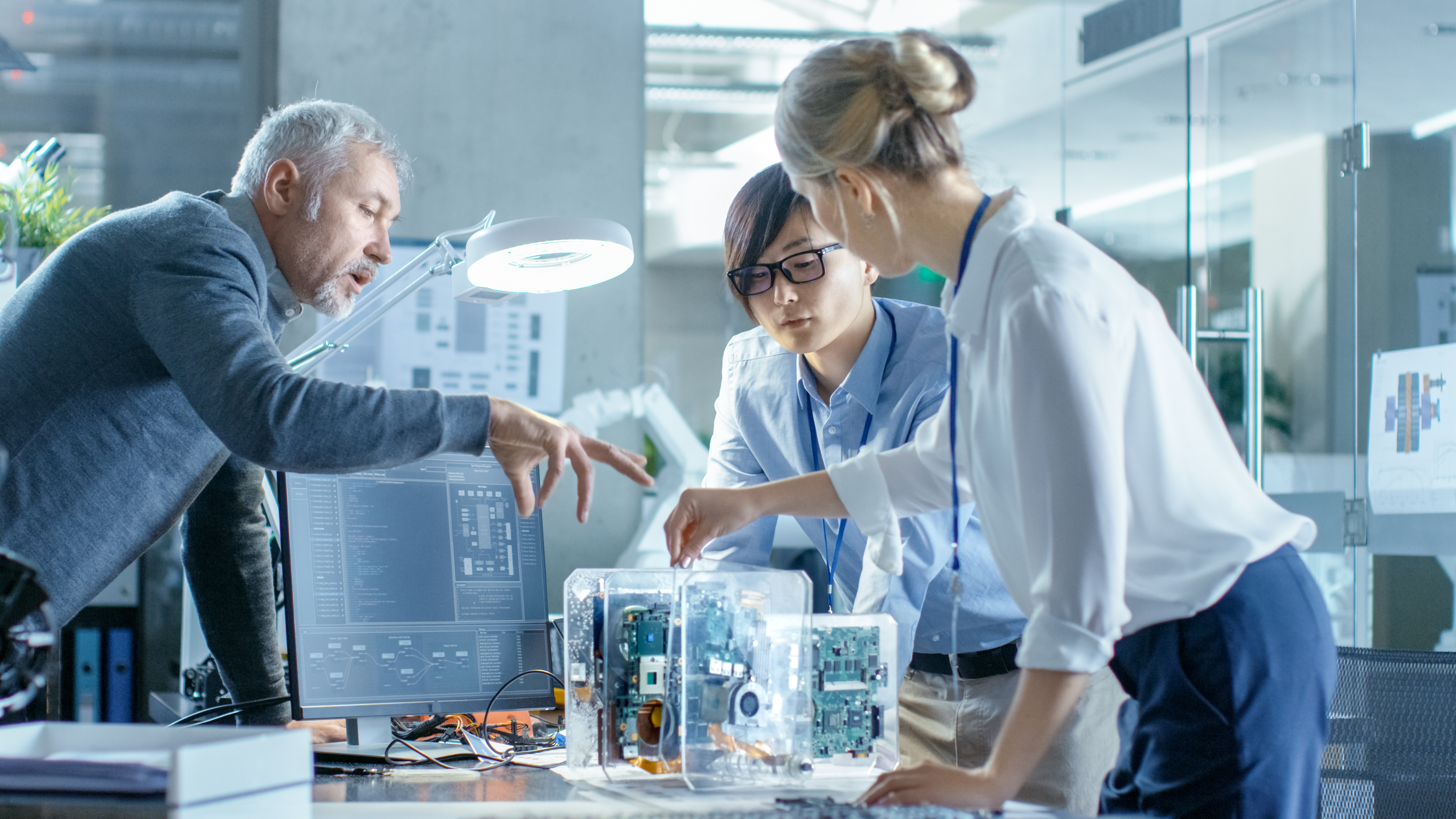 3 people working in a laboratory, rather technological