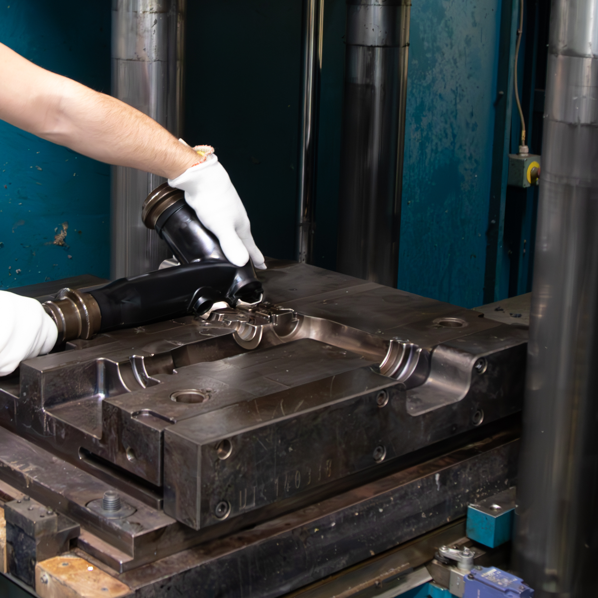 Person removing a part from a rubber injection machine