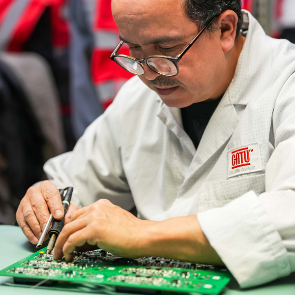 Catu employee working on an electronic board