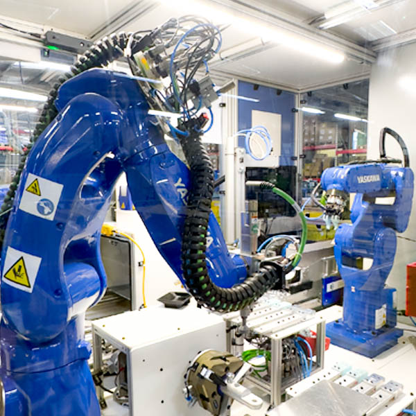 Two robotic arms make up an assembly machine