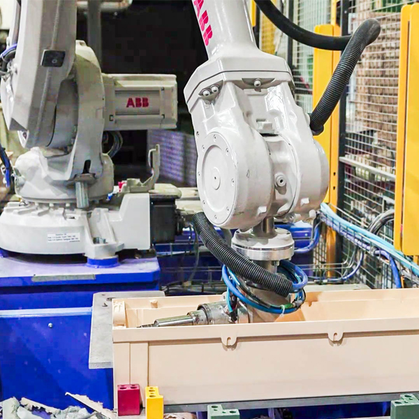 Robotic arm working on the envelope of an electrical box