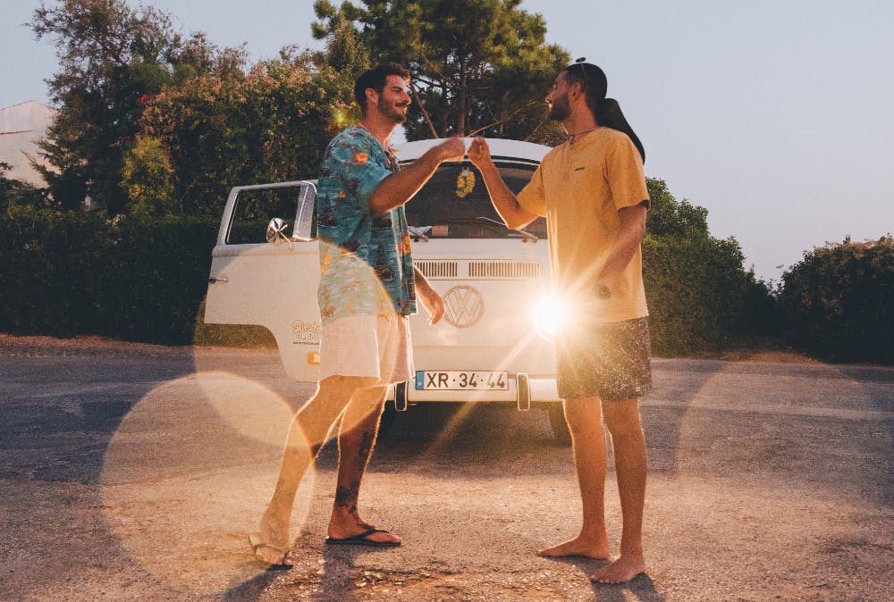 Two friends enjoying a campervan at a festival