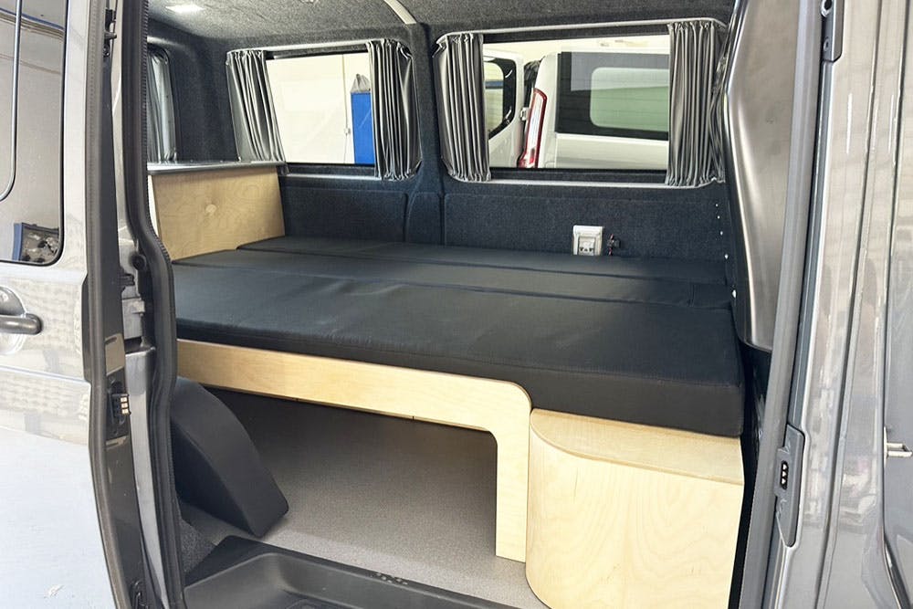 Commercial van with a removable camping kit.