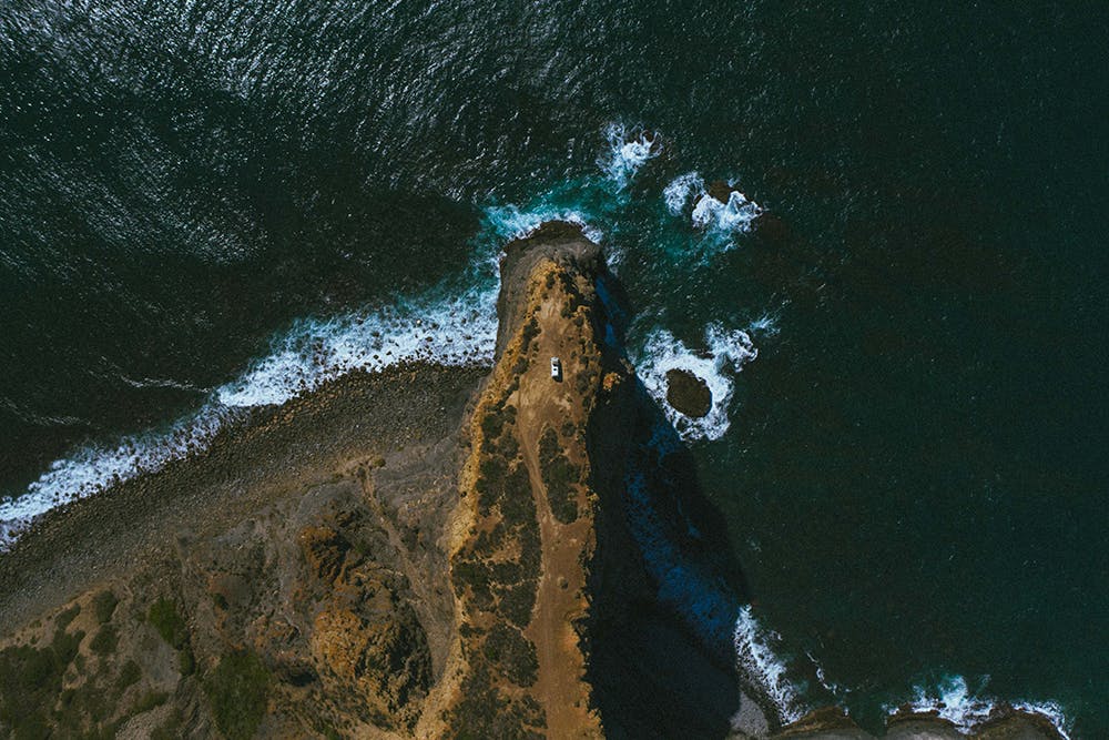 A Siesta Campers campervan reaches the end of an epic road leading to a coastal vista point. 