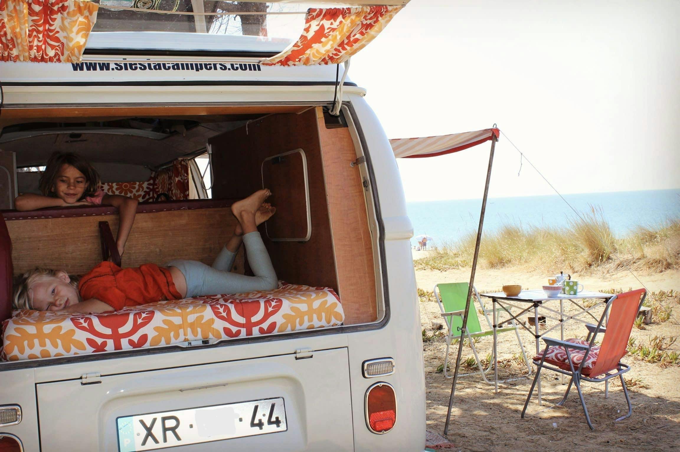 Kids enjoying their life in a van.