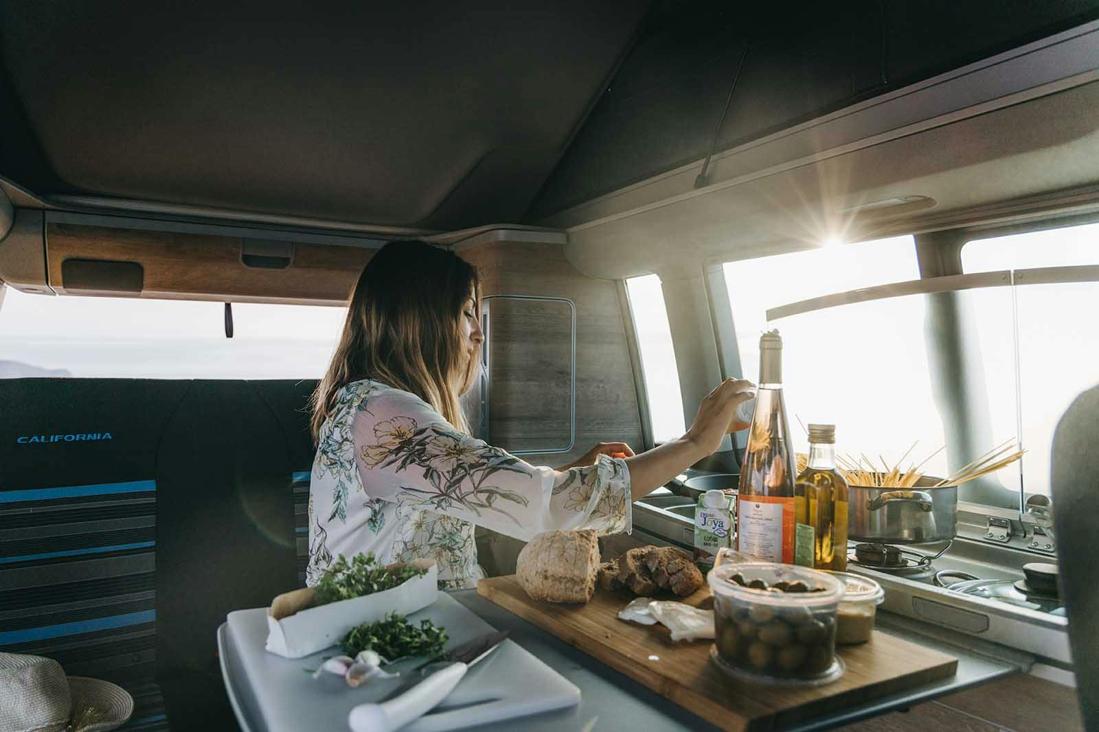 Woman enjoying wheelchair friendly campervan interior amenities.