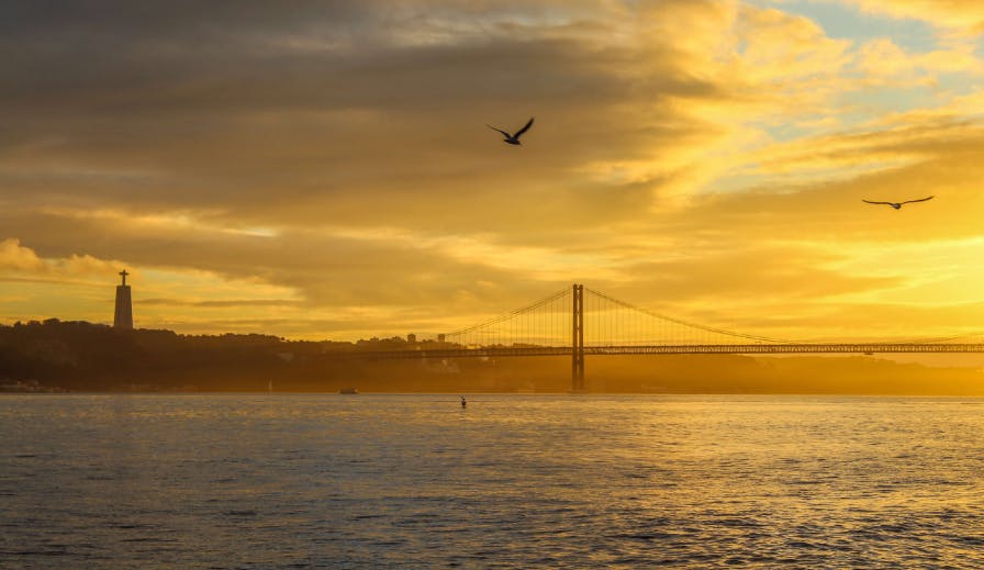 Sunset road trip drive along the Tejo river near Lisbon.