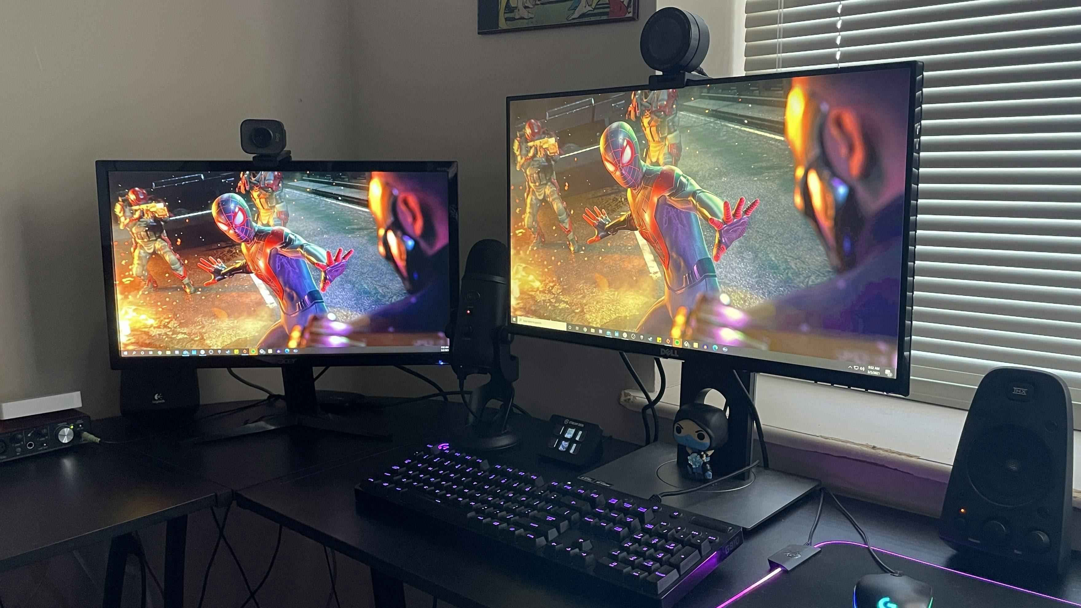 two monitors showing a Spider-man scene
