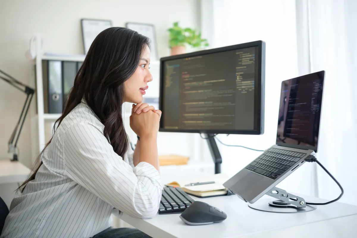 A female student is learning coding from an online AI Software Engineering Bootcamp