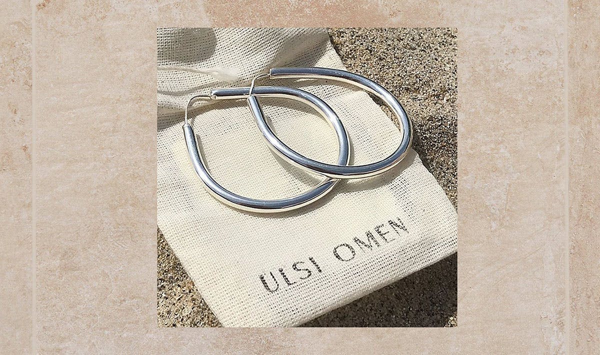 silver hoop earrings resting on an ulsi omen bag los angeles jewelry brand