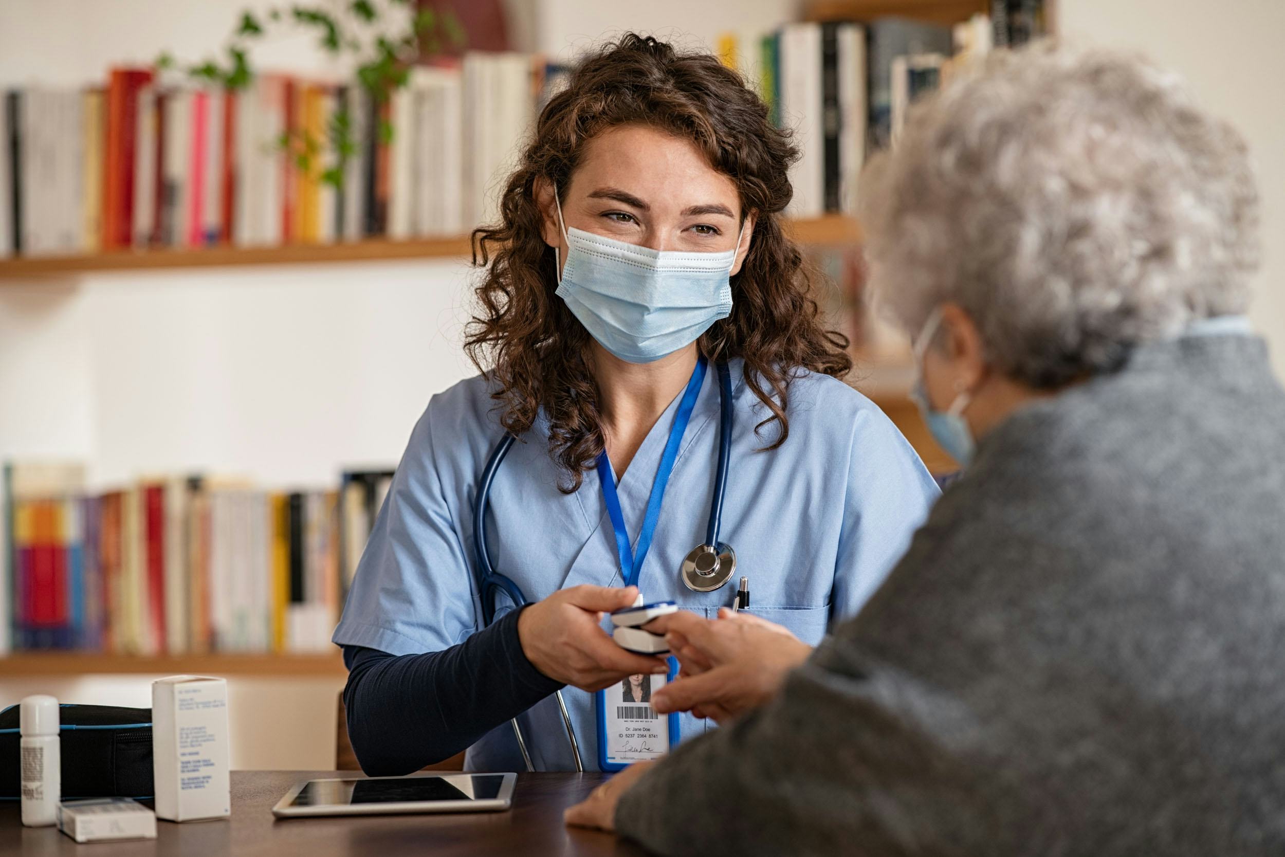 Nurse tends to an elderly women