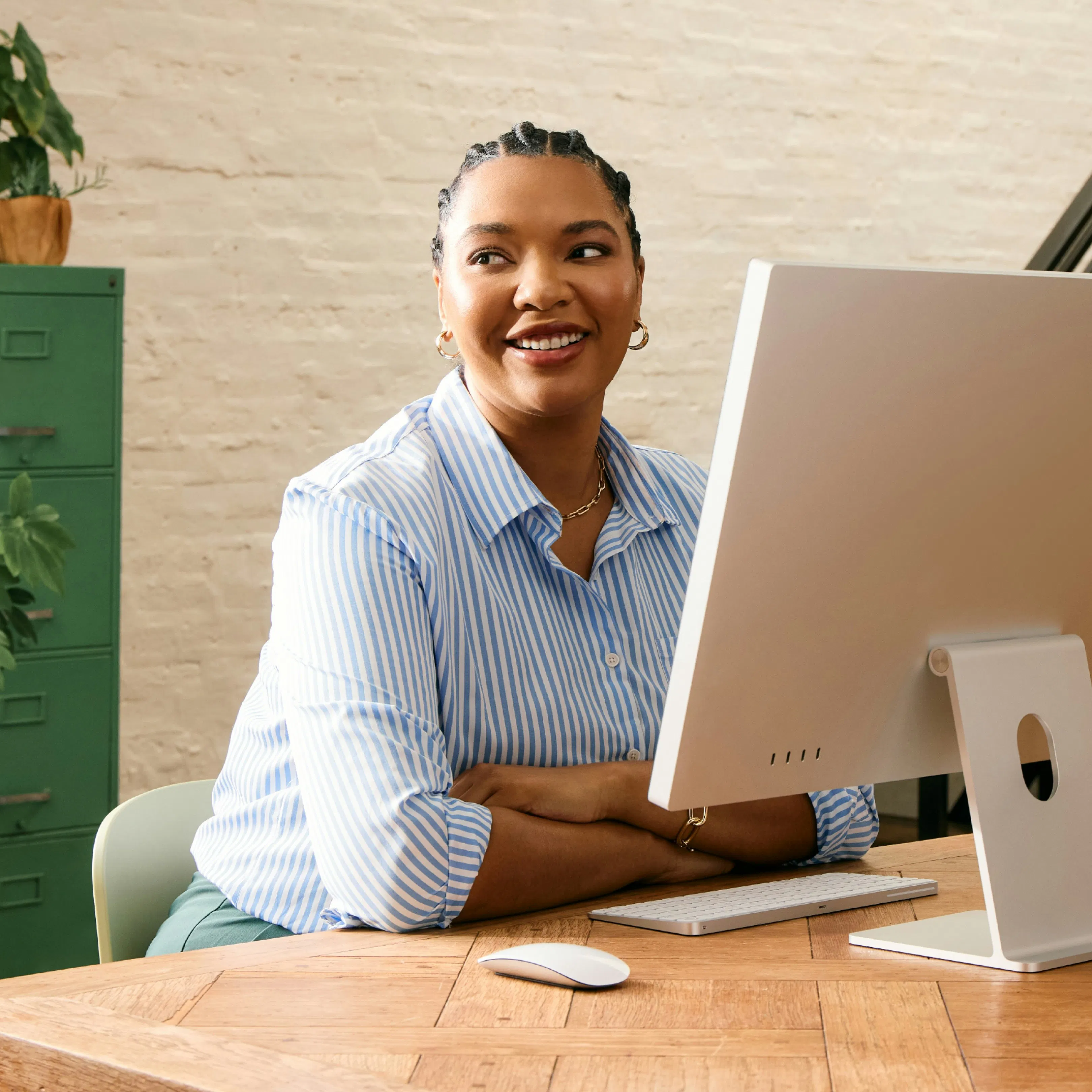 A woman smiling while working at a computer