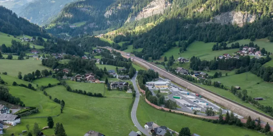 The image shows an idyllic valley in Zederhaus with wide meadows, scattered houses, and a road winding through the landscape. Surrounded by impressive mountains, it creates a calm, nature-oriented setting with a great sense of openness.
