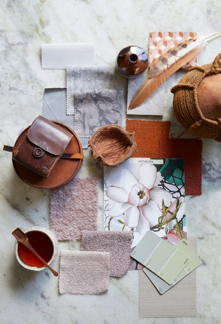 A variety of fabric samples alongside colour swatches and decorative accents curated to showcase a variety of textures.