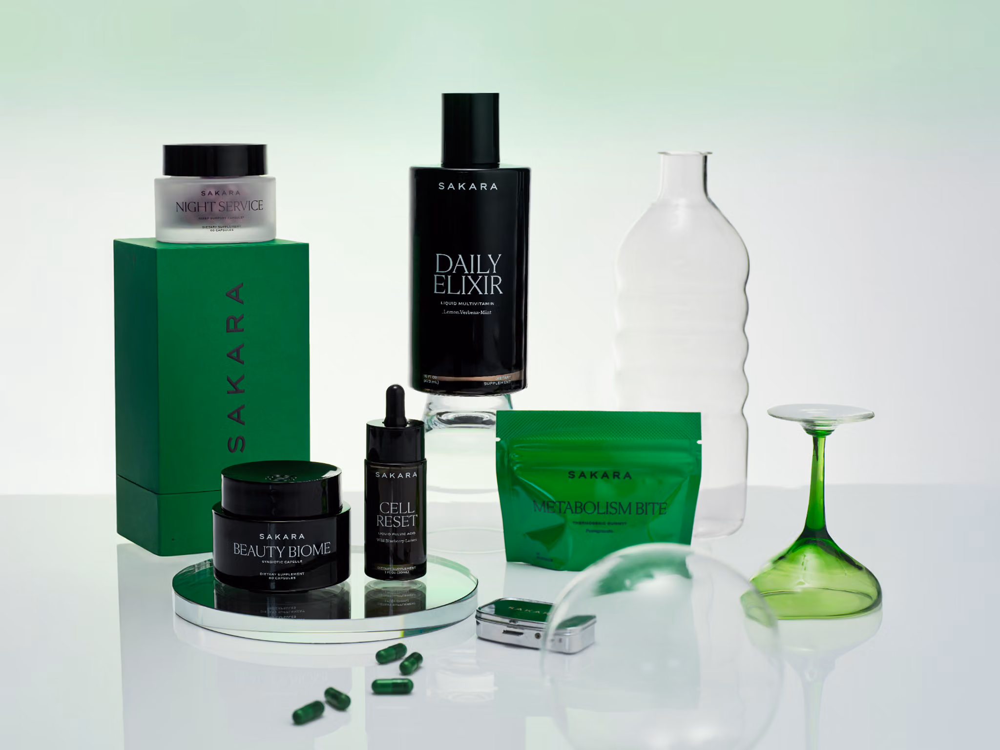 SAKARA — black supplement bottles and jars with an embossed monogram