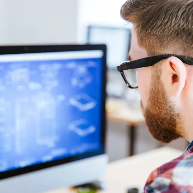 Manufacturing IT manager looking at the blueprint