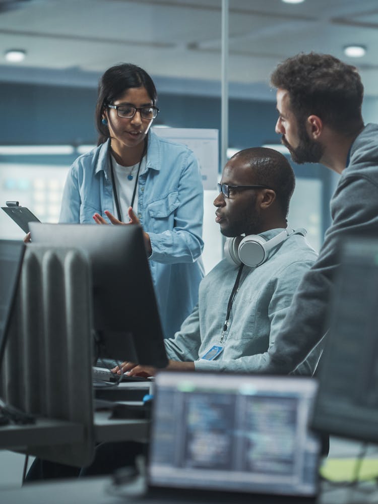 Cyber security team meeting around a computer