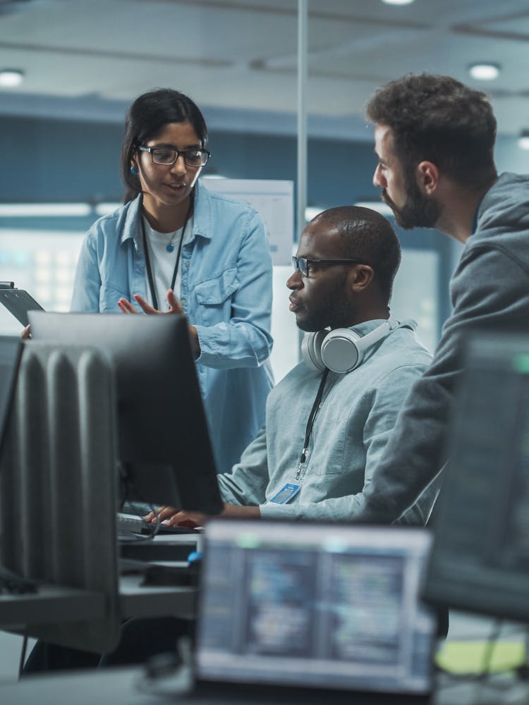 Cyber security team meeting around a computer