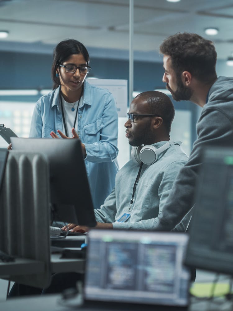 Cyber security team meeting around a computer