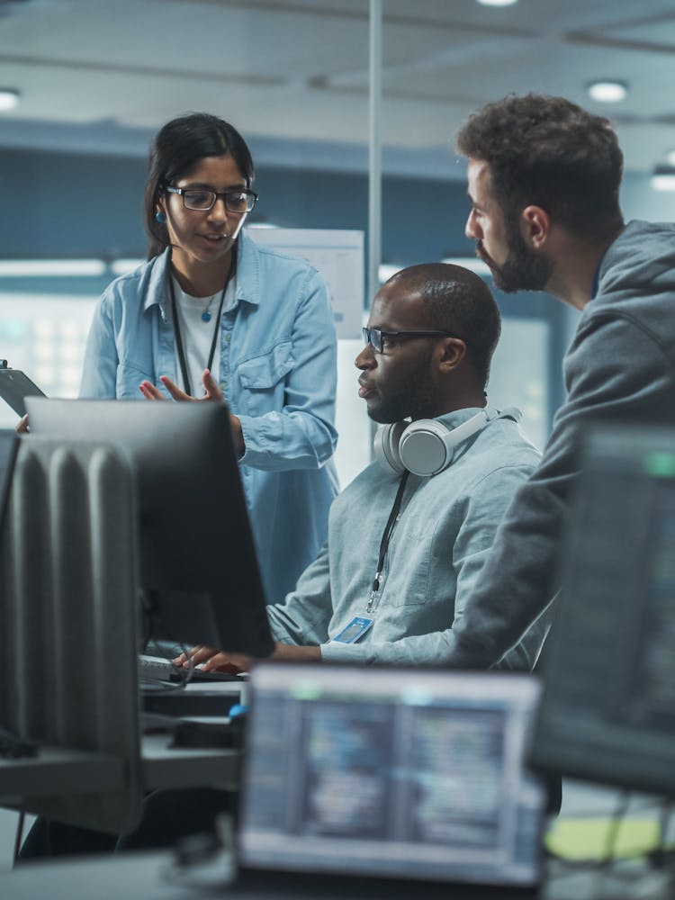 Cyber security team meeting around a computer