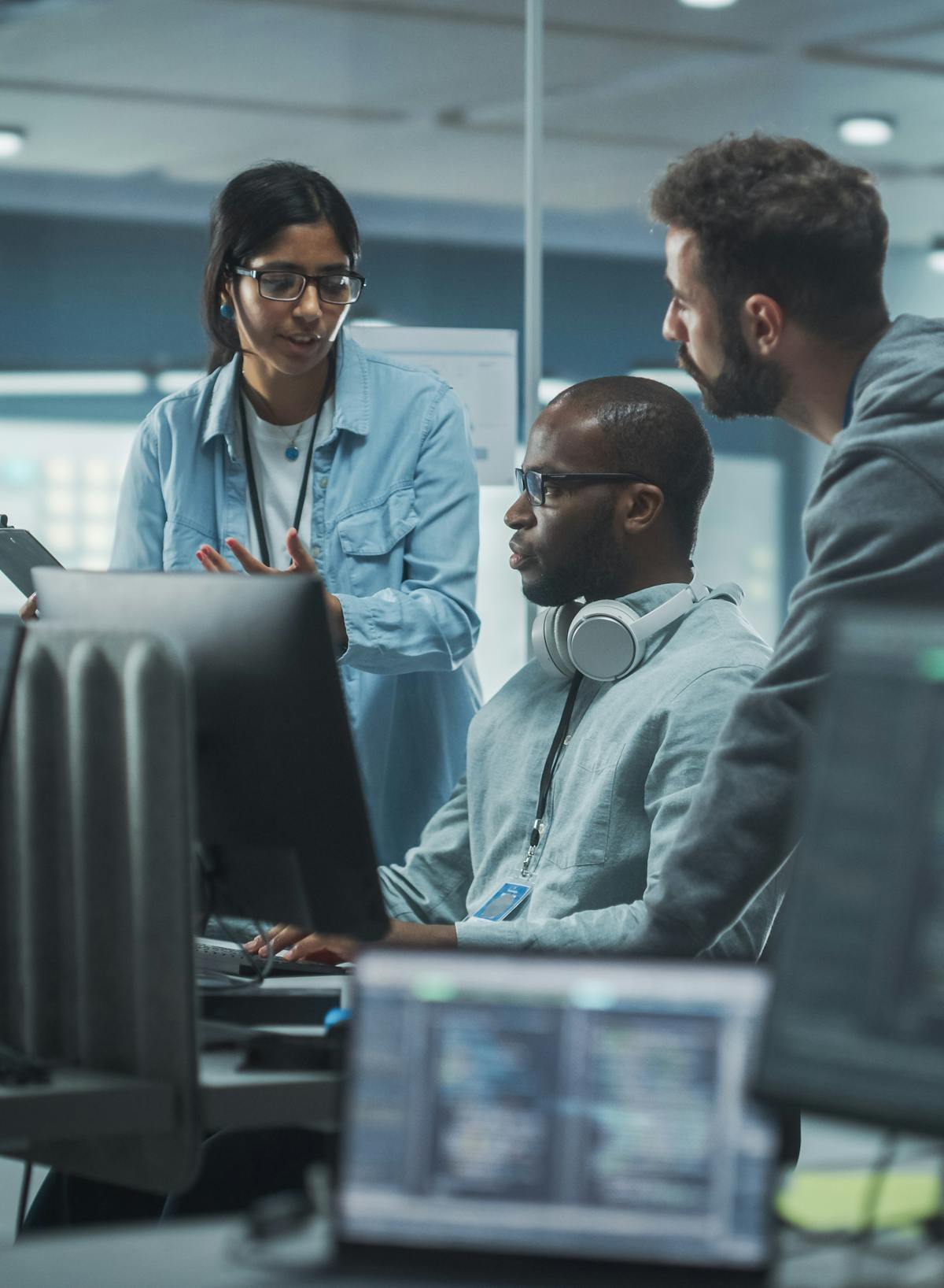 Cyber security team meeting around a computer