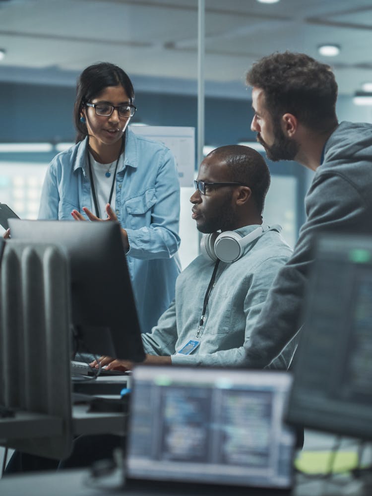 Cyber security team meeting around a computer