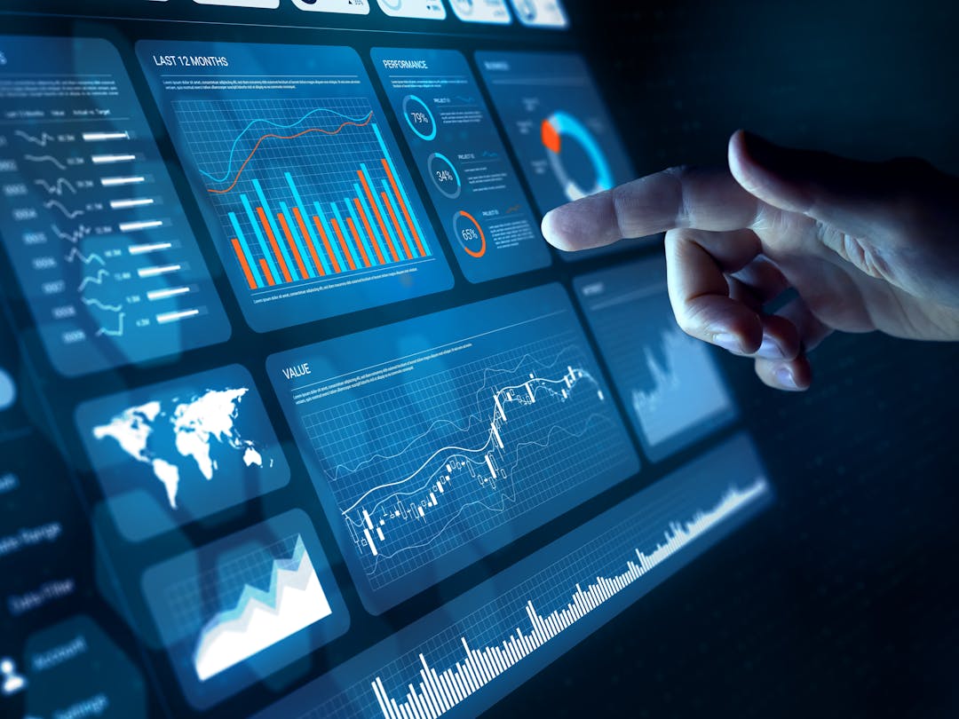 A touch screen displaying a dashboard user interface  composed of info-graphics and controls