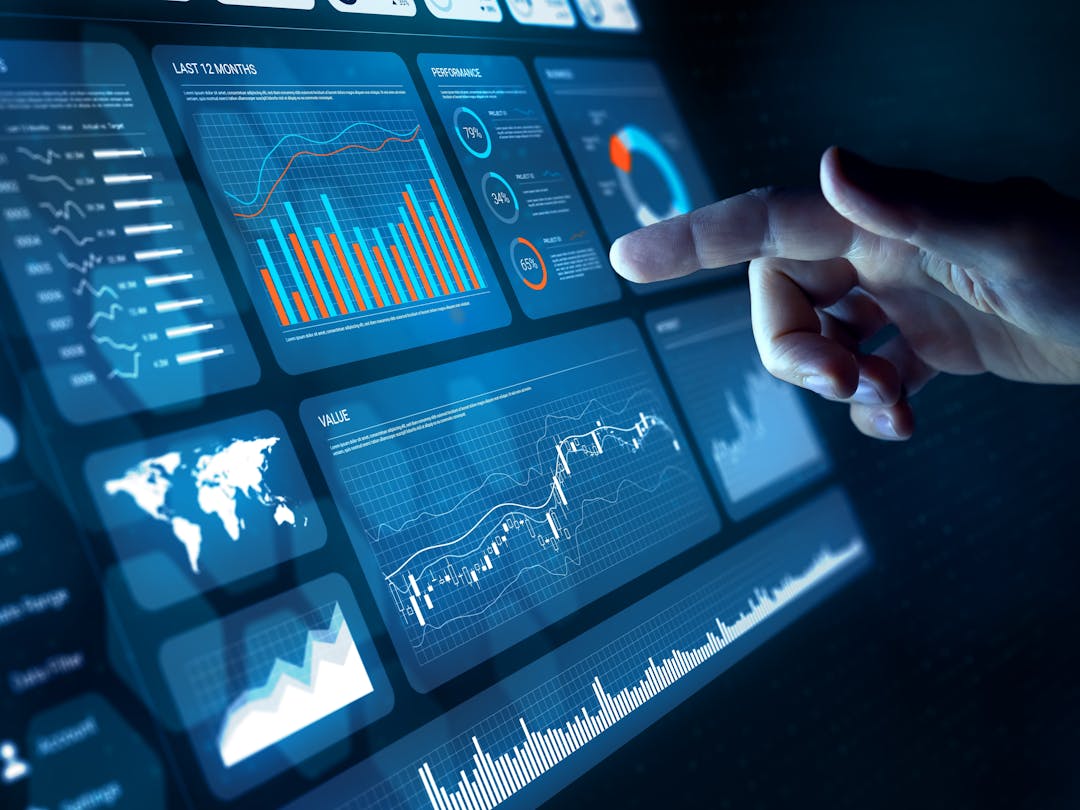 A touch screen displaying a dashboard user interface composed of info-graphics and controls
