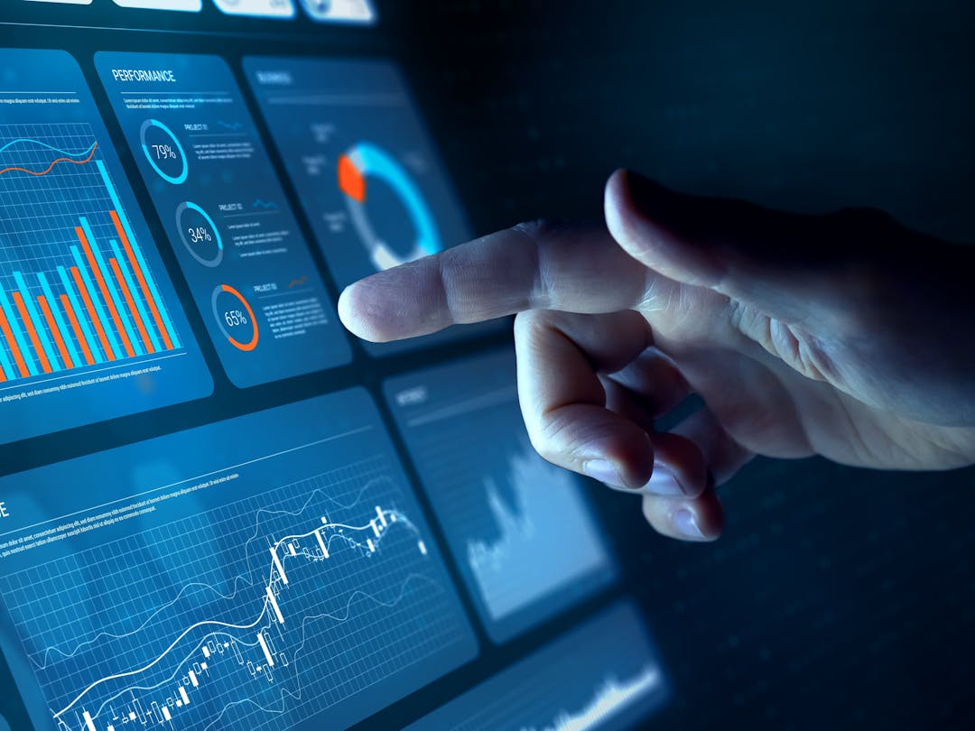 A touch screen displaying a dashboard user interface composed of info-graphics and controls