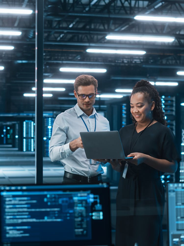 Cyber security employees in discussion in a server data center