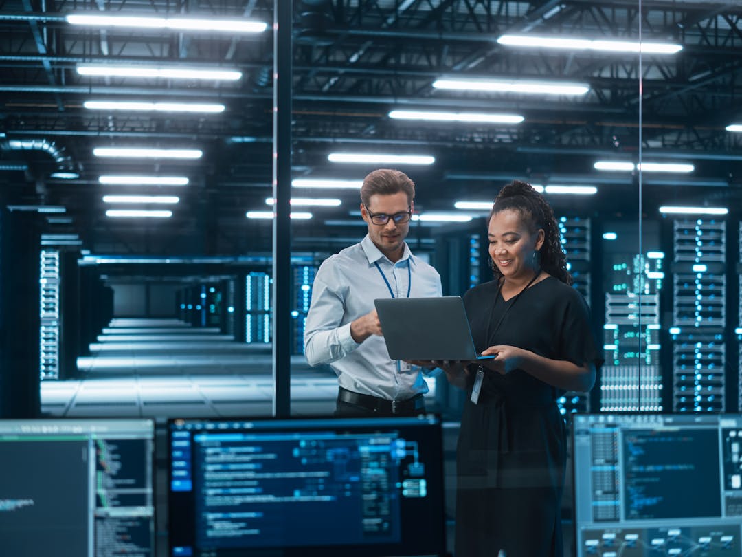 Cyber security employees in discussion in a server data center